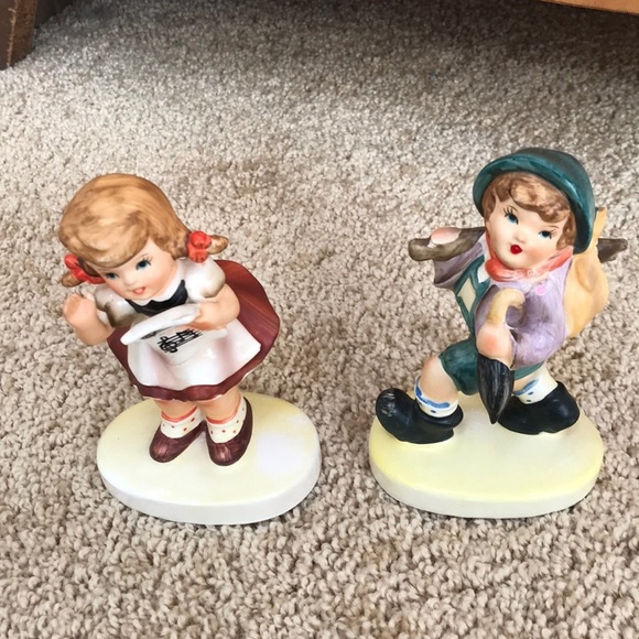 FIGURINES of a girl singing and boy with bundle